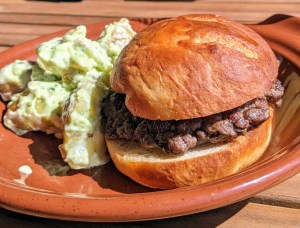 Lunch at Row Fourteen on the patio: burger with warm potato salad