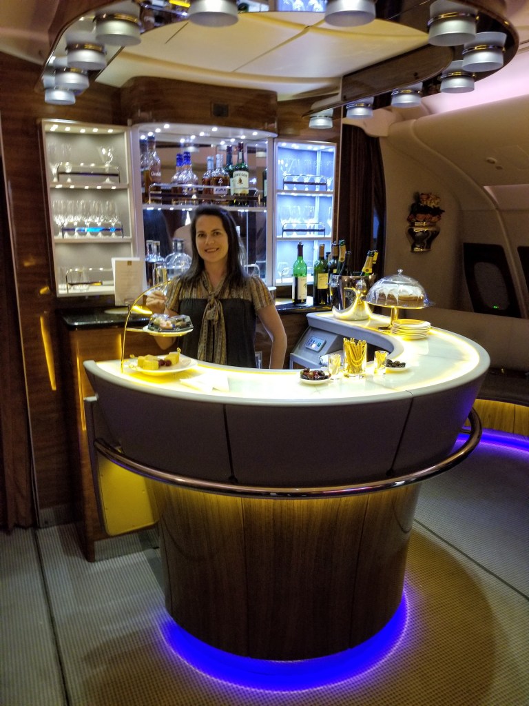 Max at the bar drinking Veuve Clicquot, which tastes like mouthwash after having Dom Perignon