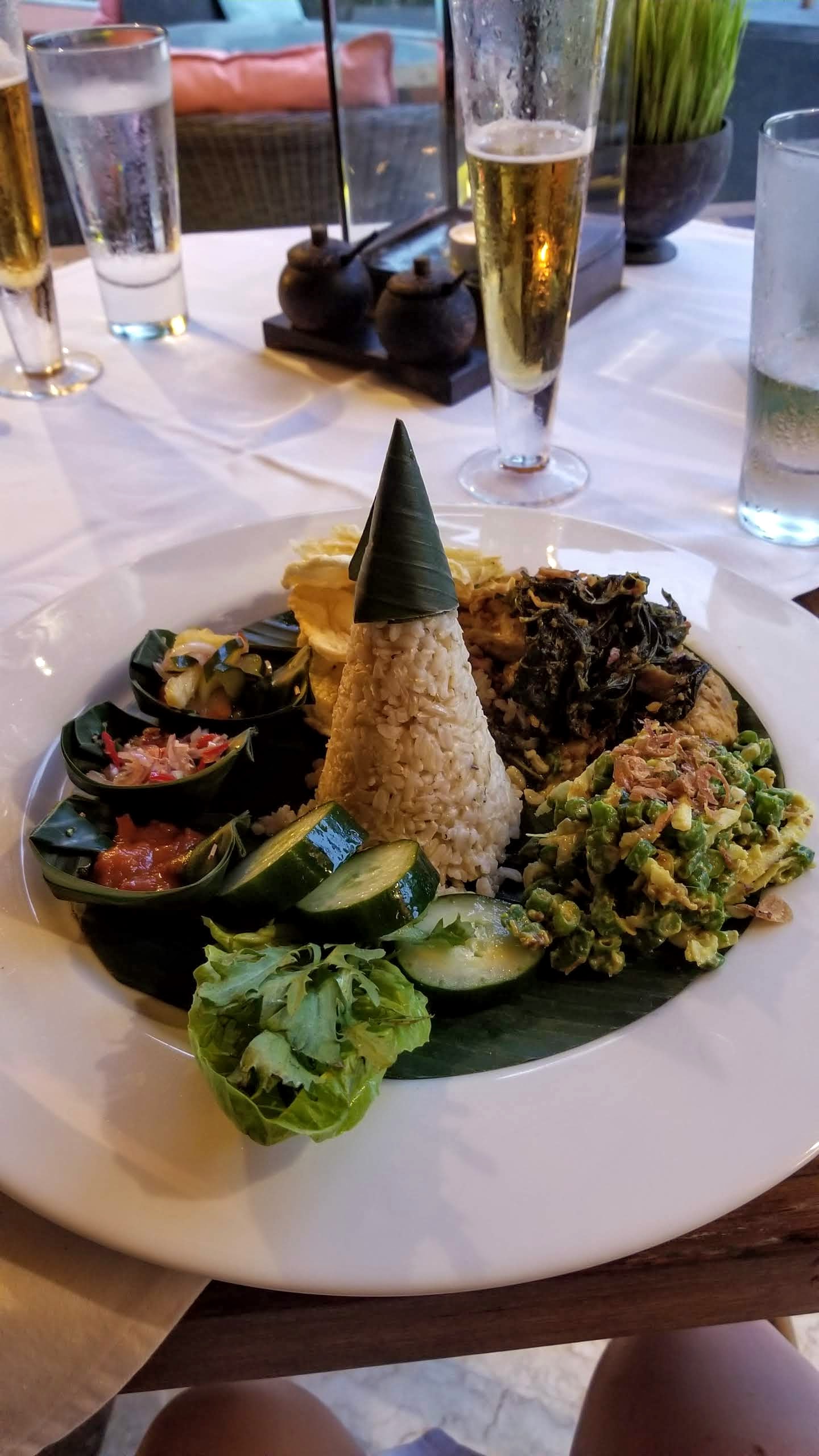 Chicken dish served with Balinese sambals, rice, and veggies