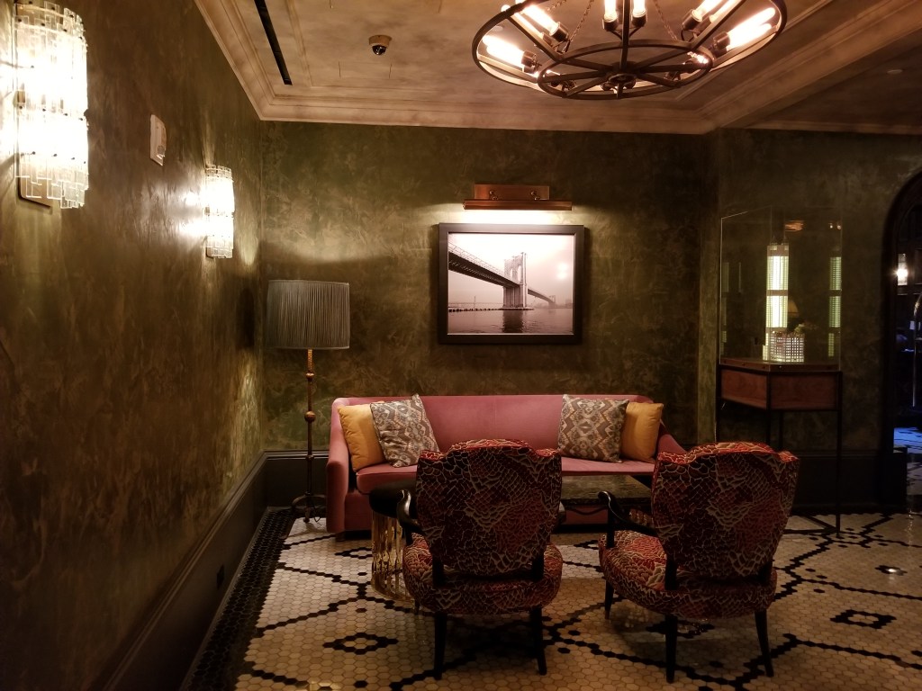 Seating area by the concierge desk in The Beekman Hotel