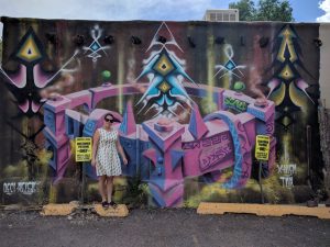 Max and a mural in Santa Fe