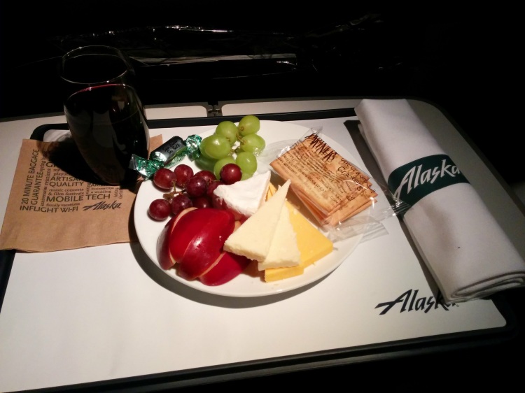 The Alaska Airlines Fruit and Cheese Plate with a glass of Browns Cabernet.