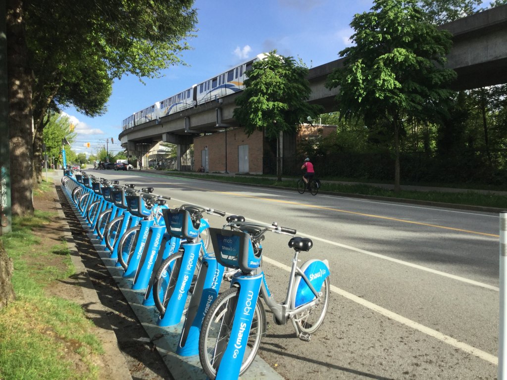 Mobi Bike Share and the Sky Train by Commercial Drive