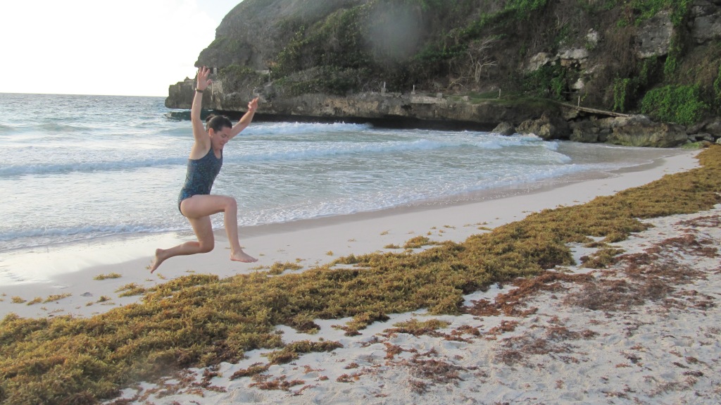Me jumping over some sargassum seaweed on Crane Beach in Barbados