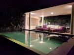 Outdoor seating and pool at night in the Bamboo 2 Villa