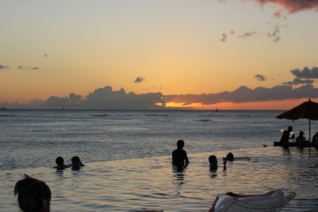 Adult infinity pool at sunset at the Sheraton Waikiki
