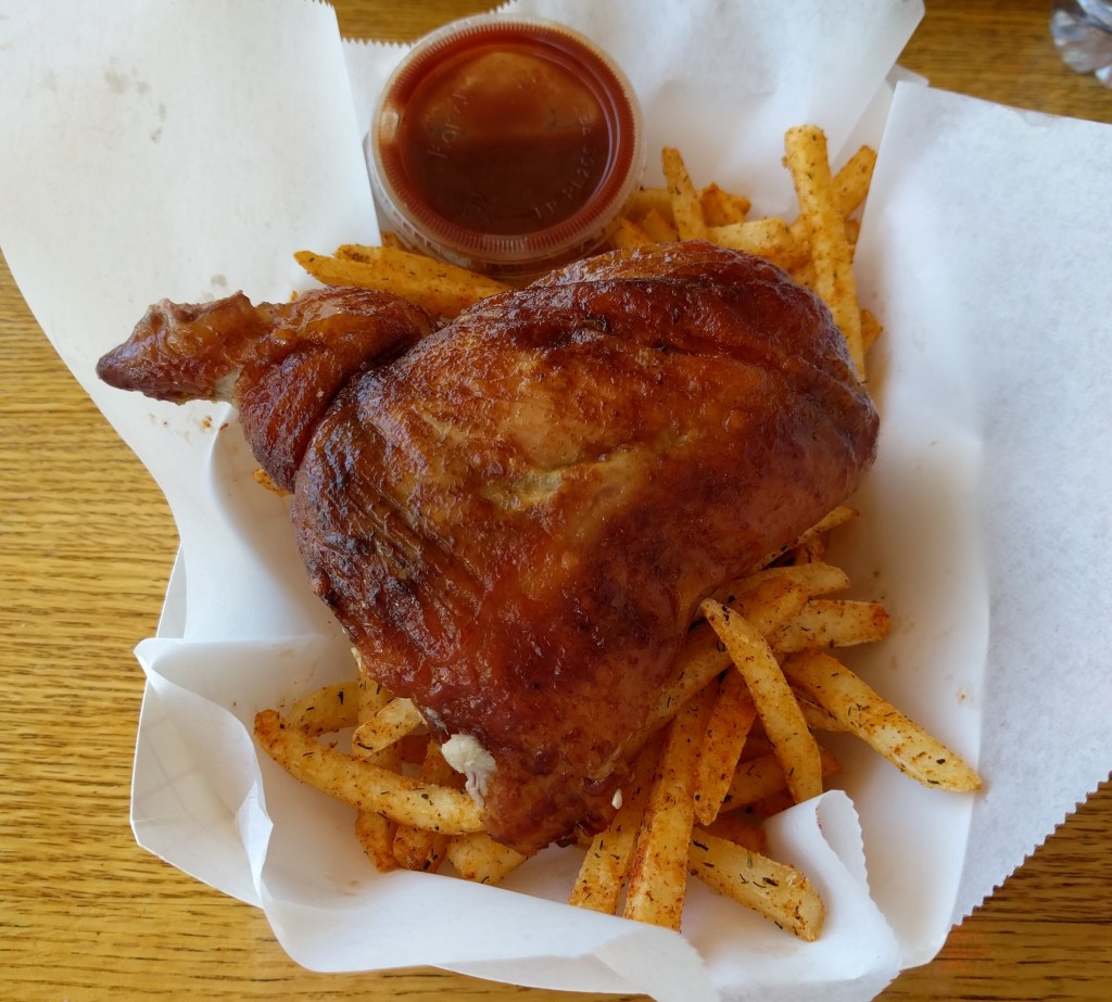 Half chicken with cajun fries and spicy sauce