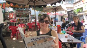 Max reading the newspaper at the Lunch Lady stall in HCM