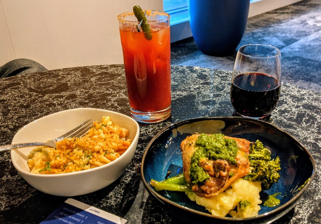 YYC WestJet Elevation Lounge: WestJet Double Undercut (left) and red wine (left) with mac 'n cheese and the chicken thigh dish
