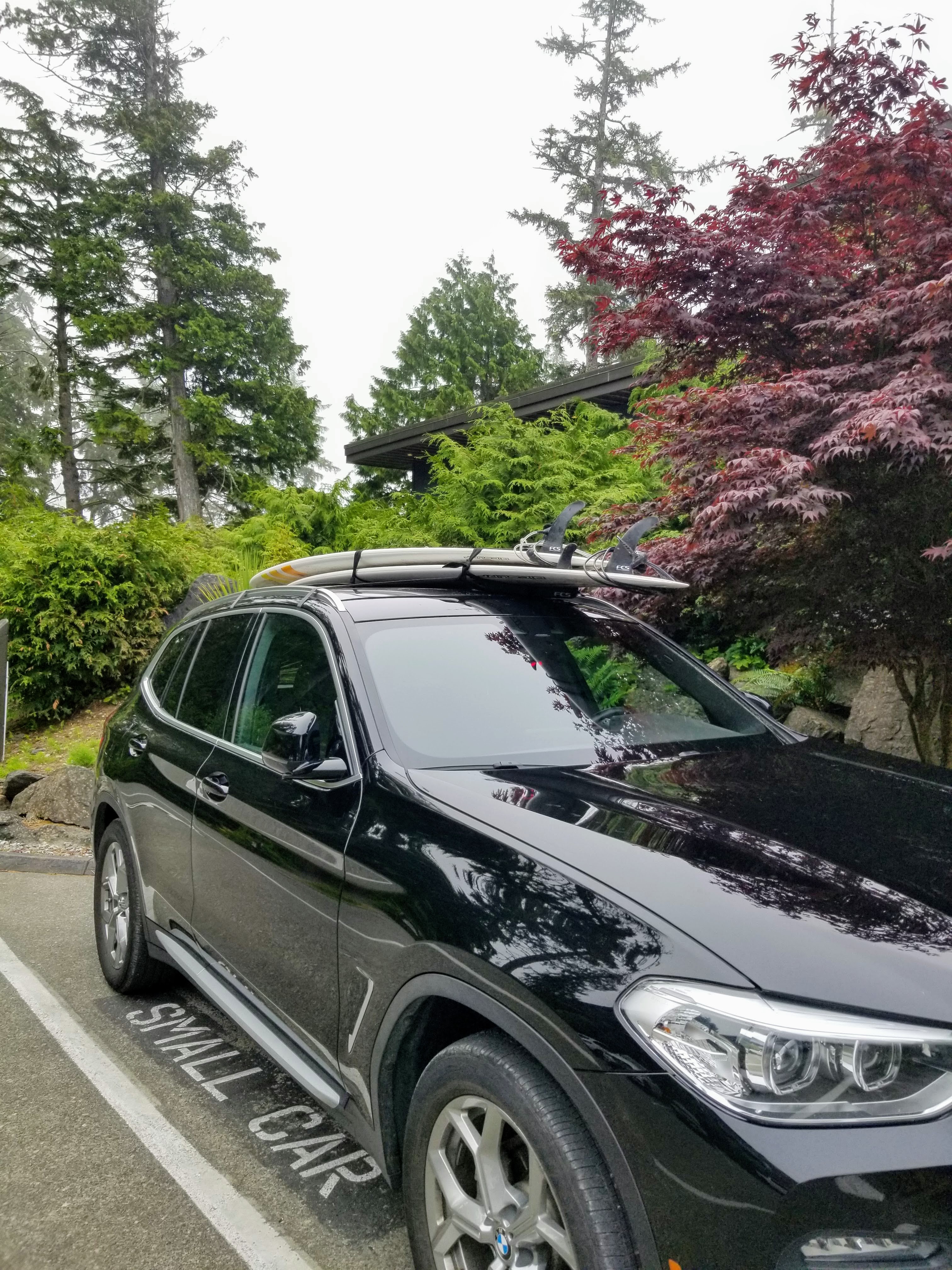 Car with a surfboard on the roof