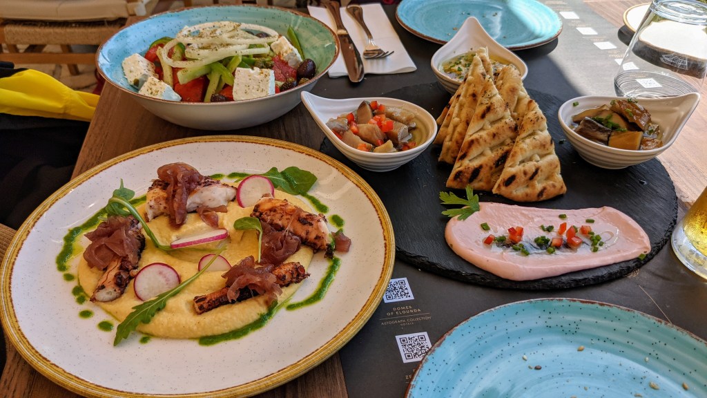 Lunch at Domes of Corfu: grilled octopus with fava beans, Greek salad, and seafood sampler of cured fish and dips