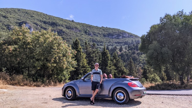 Jason with the car in the hills of Corfu