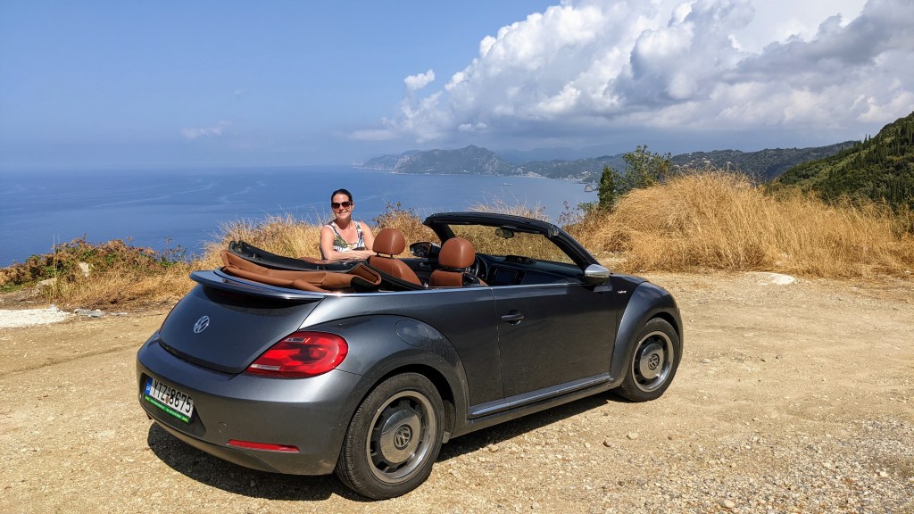 Max with the car in the hills of Corfu